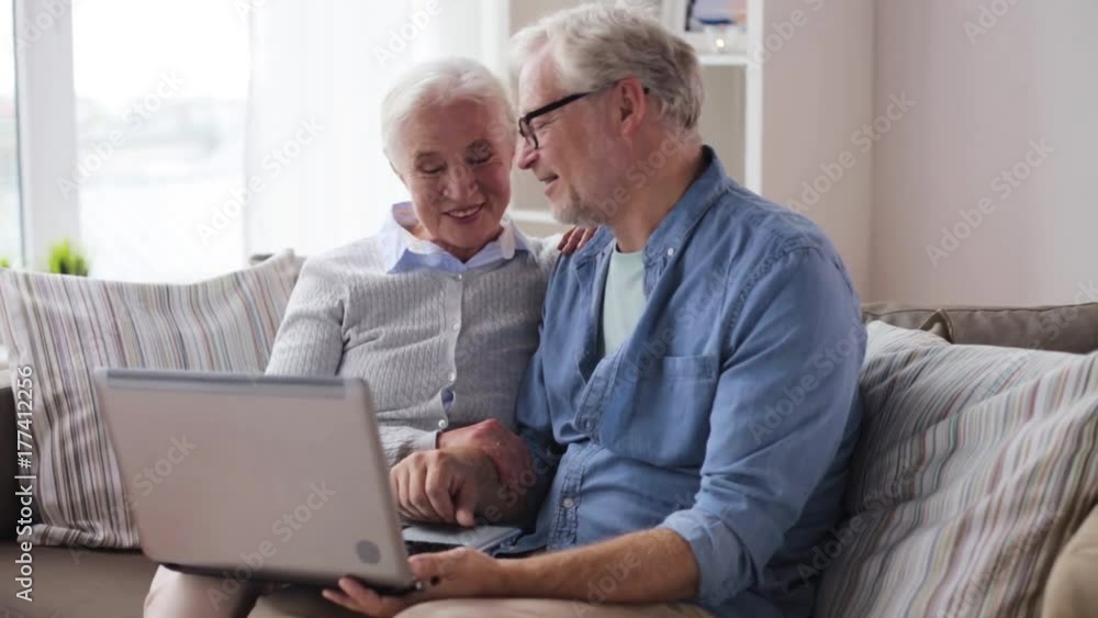 senior couple having video chat on laptop at home senior couple having video chat on laptop at home