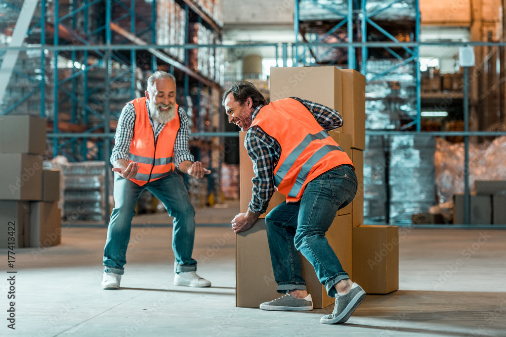 Fototapeta premium warehouse workers moving boxes