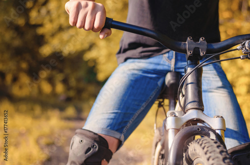 Close-up of a young man's hand on the wheel of a mountain © olegphotor