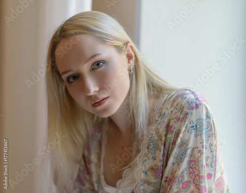 The girl at the window. Selective soft focus.