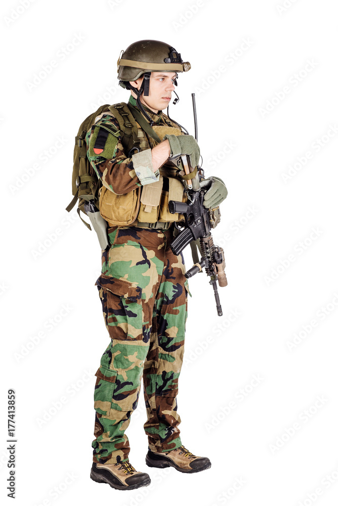 Portrait soldier or private military contractor holding sniper rifle.