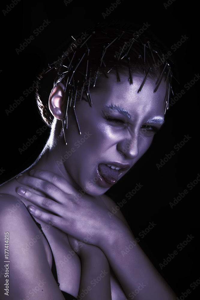 Unusual makeup of beautiful girl with nails in her head Unusual makeup of beautiful girl with nails in her head