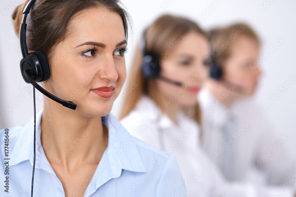 Call center. Focus on beautiful business woman in headset Call center. Focus on beautiful business woman in headset