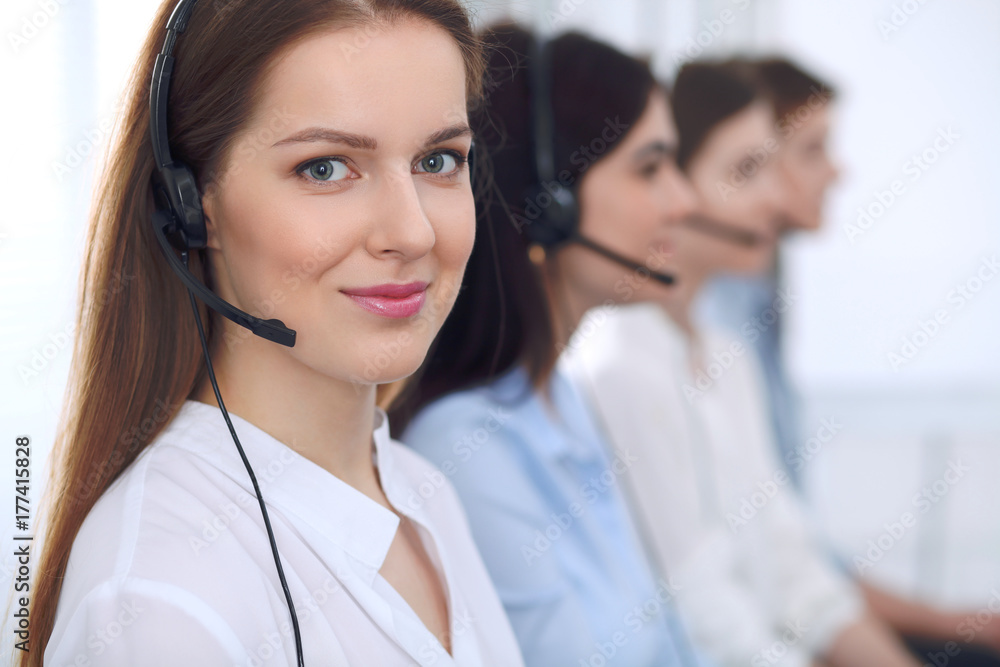 Call center operator.Young beautiful business woman in headset Call center operator.Young beautiful business woman in headset
