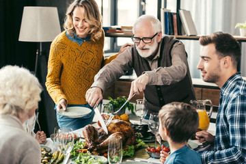 grandfather cutting turkey for family