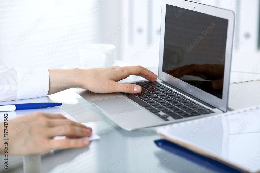 Close up of business woman hands typing on laptop computer Close up of business woman hands typing on laptop computer
