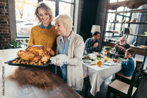 senior mother and daughter with thanksgiving turkey