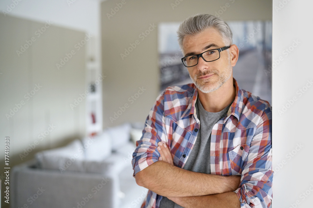 Smiling 40-year-old man standing at home Smiling 40-year-old man standing at home