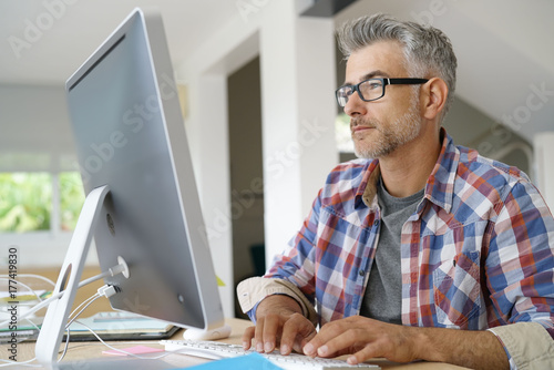 Startup businessman working in office on desktop computer