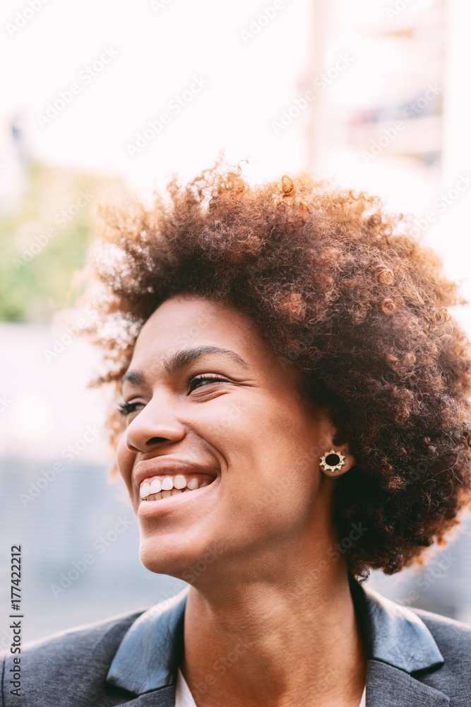 Portrait of beautiful afro american businesswoman smiling in outdoors. Portrait of beautiful afro american businesswoman smiling in outdoors.