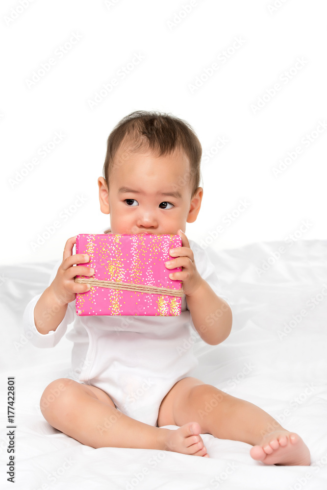 asian toddler with wrapped present asian toddler with wrapped present