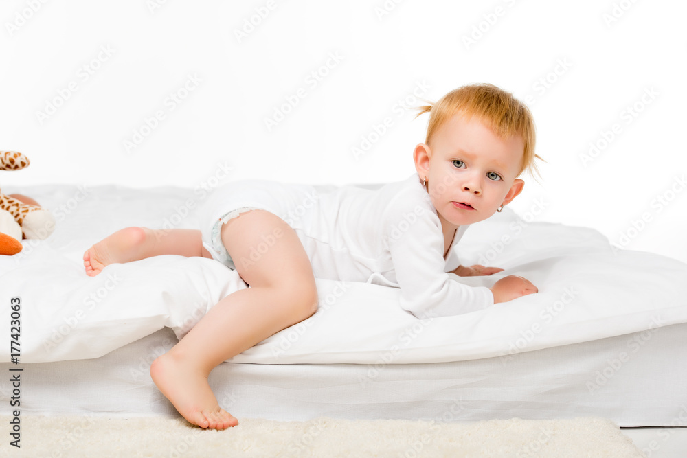 baby lying on bed