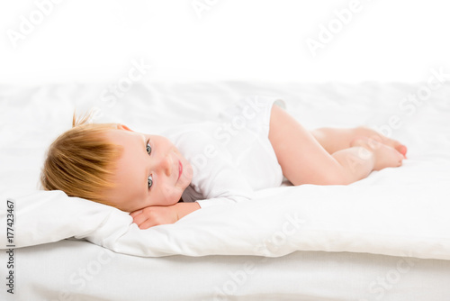 baby lying on bed