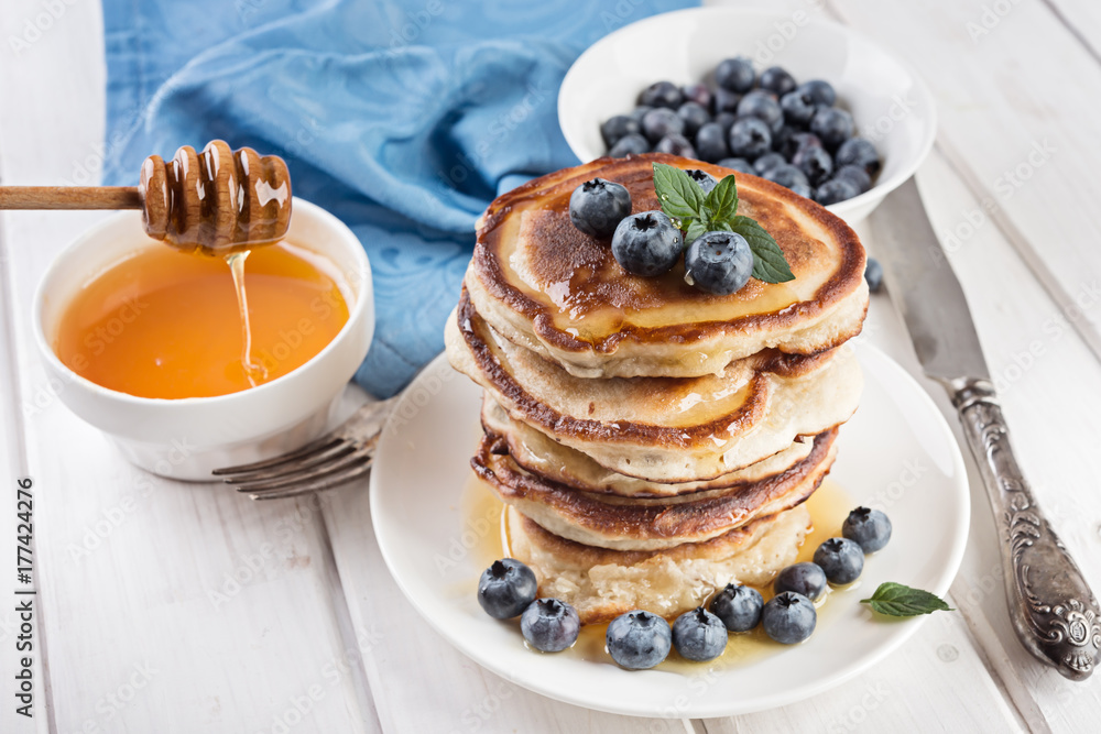 pancakes in a stack with berries and honey pancakes in a stack with berries and honey