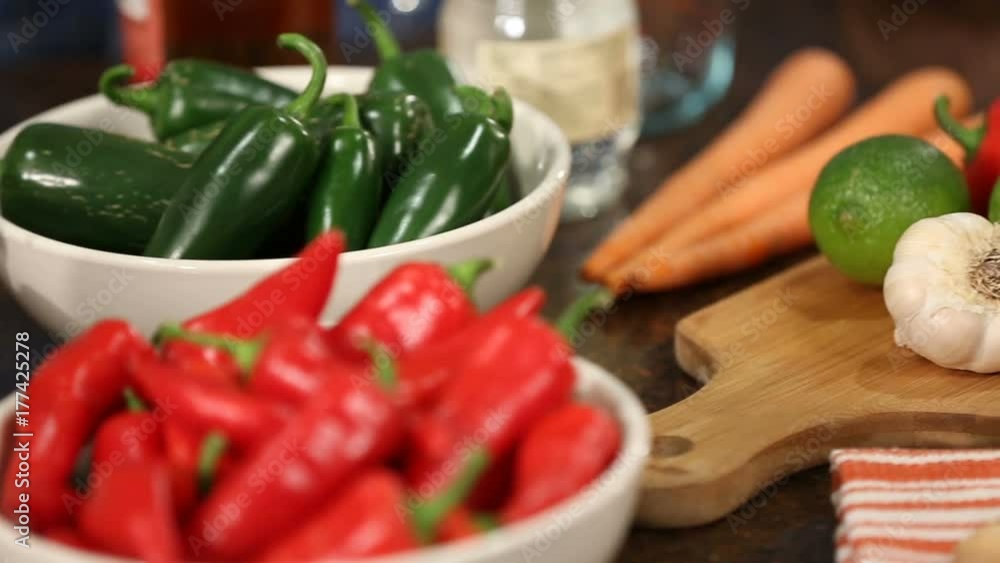 Peppers and Ingredients Panning Right. a close up panning right shot of bowls of peppers and carrots, lemons, garlic and onions. Ingredients for a meal
Peppers and Ingredients Panning Right. a close up panning right shot of bowls of peppers and carrots, lemons, garlic and onions. Ingredients for a meal