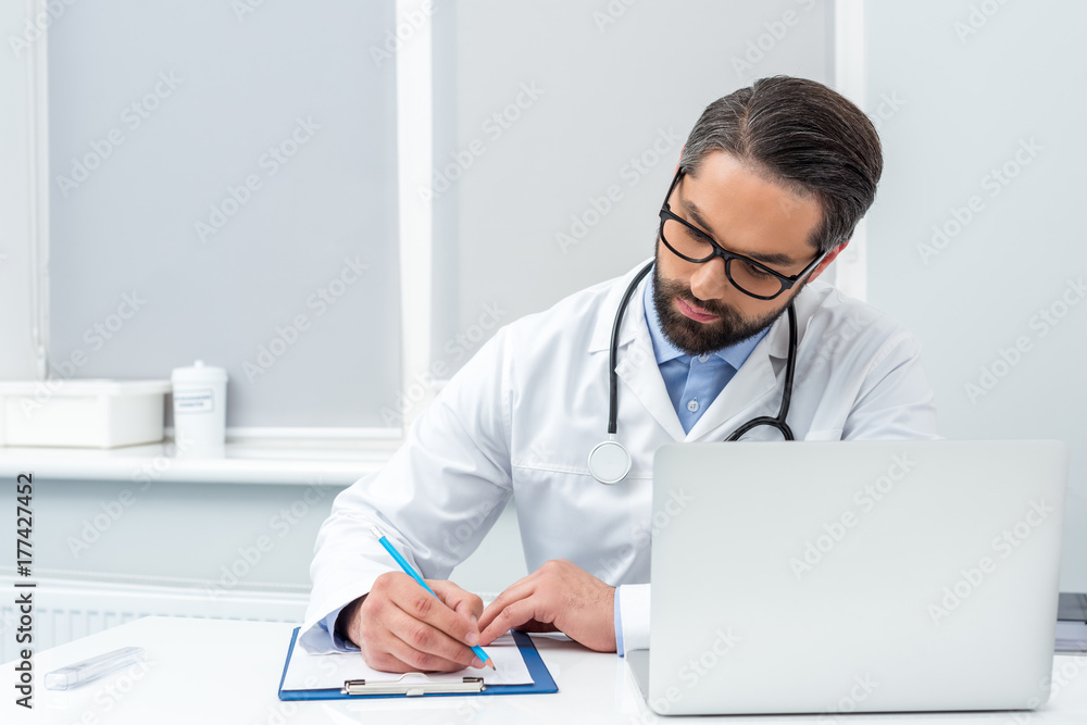 doctor writing in clipboard doctor writing in clipboard