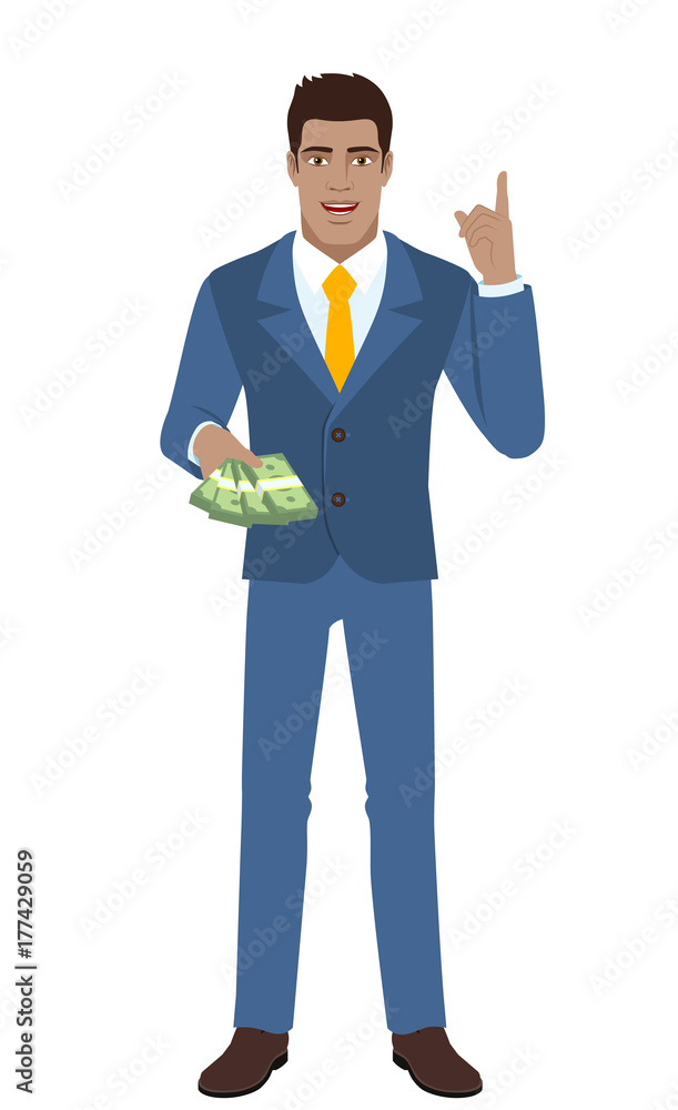 Businessman with money pointing index finger up Businessman with money pointing index finger up