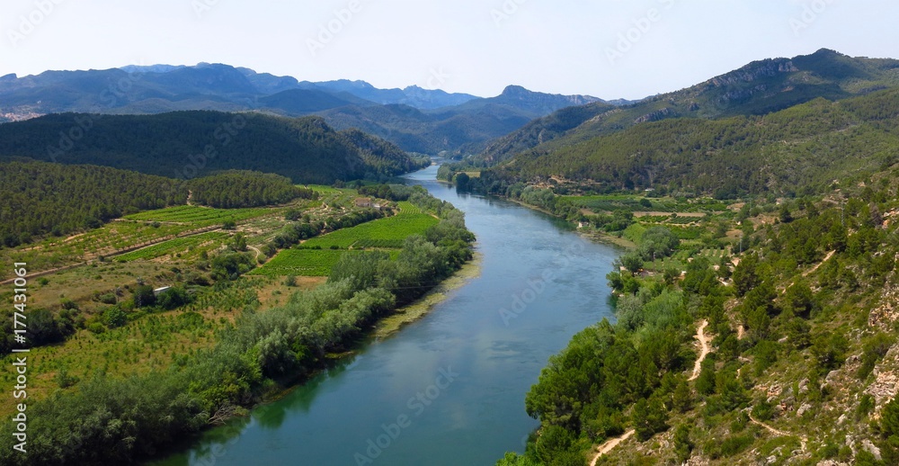 Panorama of Ebro River valley and farm fields in Catalonia, Spain viewed from above. View from Miravet village.