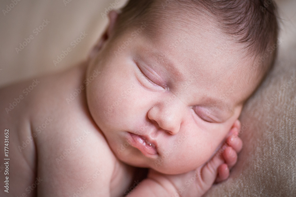 Sleeping newborn baby girl. Sleeping on a covered sheet. Sleeping newborn baby girl. Sleeping on a covered sheet.