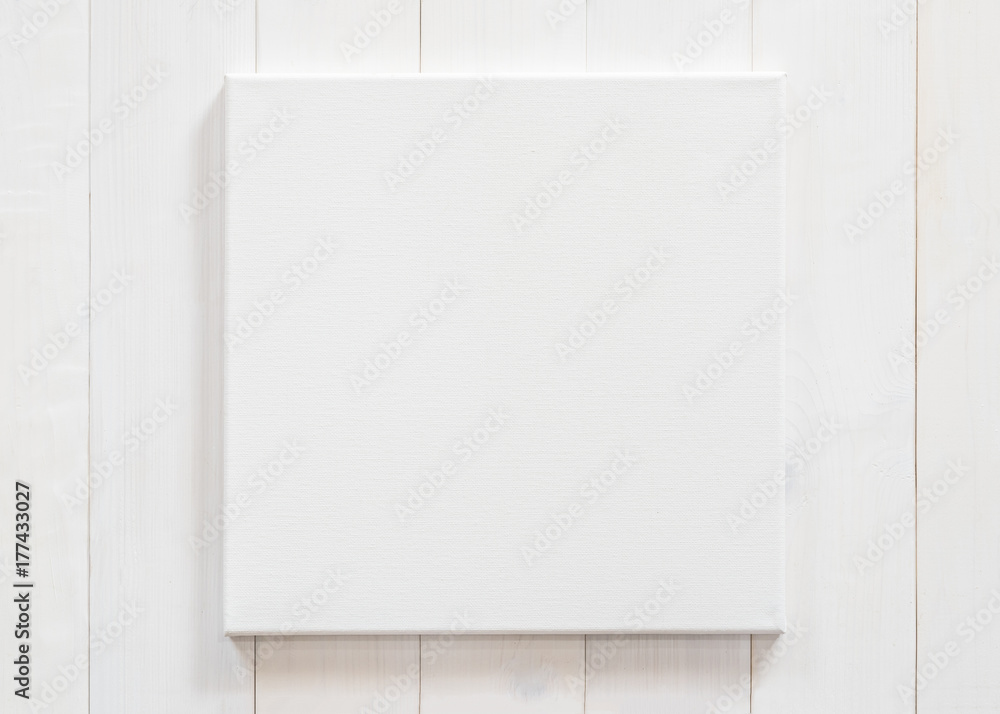 White canvas frame mock up template square size on white wood wall for arts painting and photo hanging interior decoration - obrazy, fototapety, plakaty 