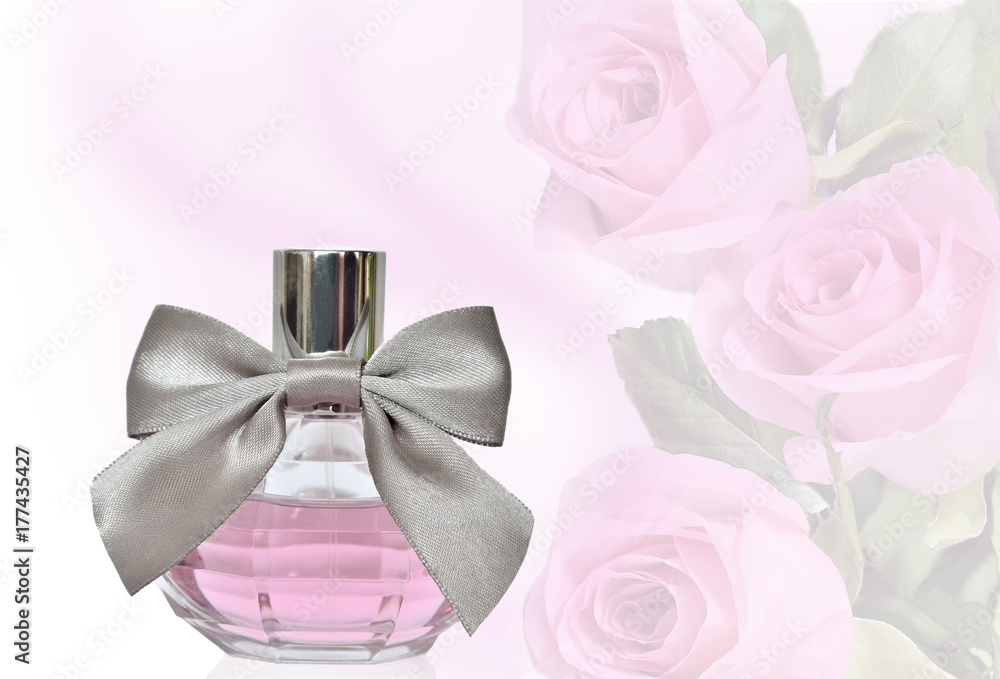 Female perfume in bottle with bow on a floral background Female perfume in bottle with bow on a floral background