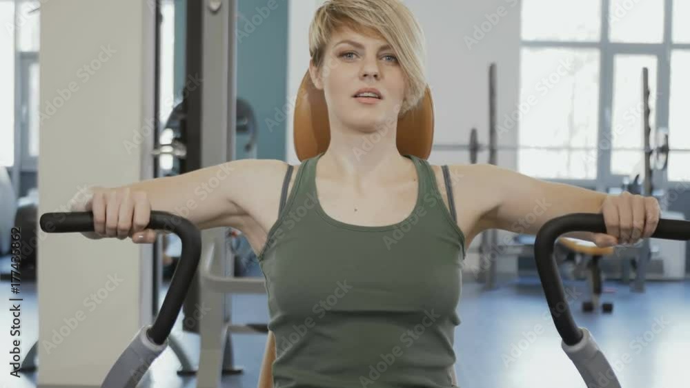 Young woman train her back at training apparatus Young woman train her back at training apparatus
