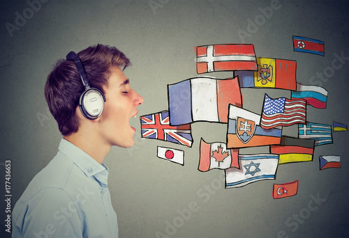 Young man in headphones learning different languages