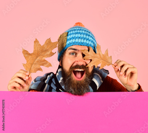 Hipster with beard and happy face wears warm clothes