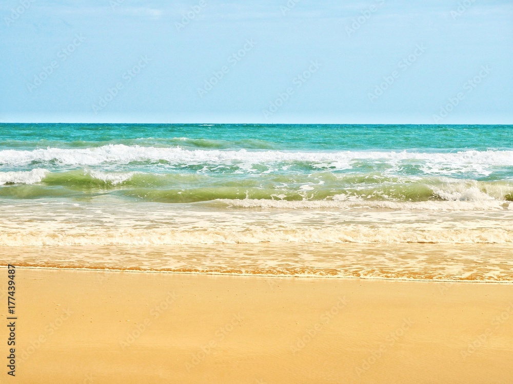Landscape scene of beautiful tropical sea with clean beach and blue sky on sunny day. Concept for holiday and vacation. Landscape scene of beautiful tropical sea with clean beach and blue sky on sunny day. Concept for holiday and vacation.
