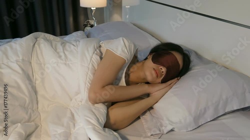 4k of Beautiful young woman sleeping with sleep mask in her bed at home