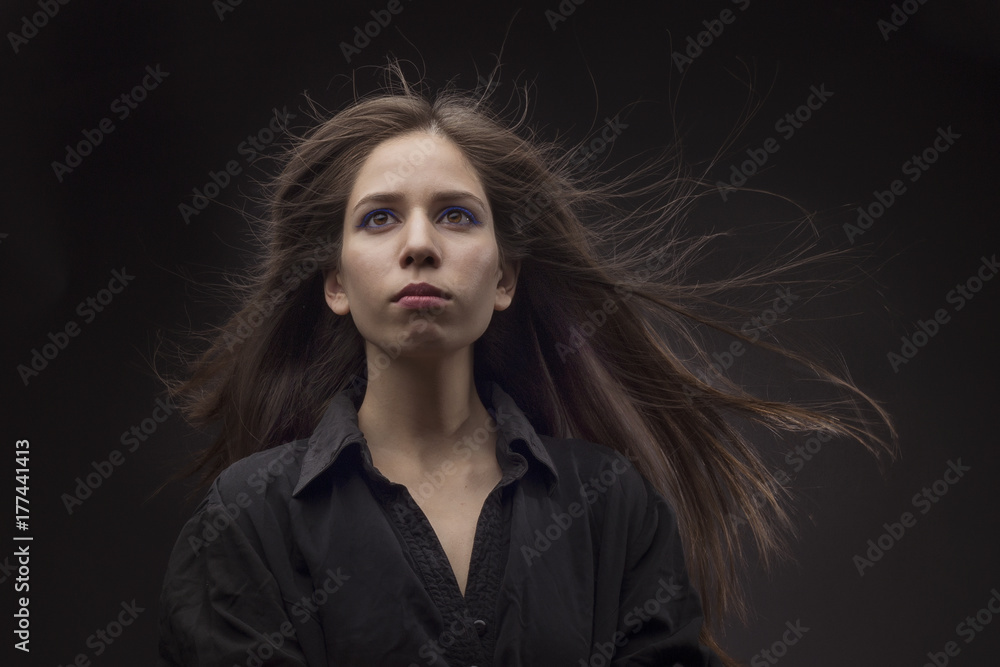 Fototapeta premium Girl with long hair on a black background