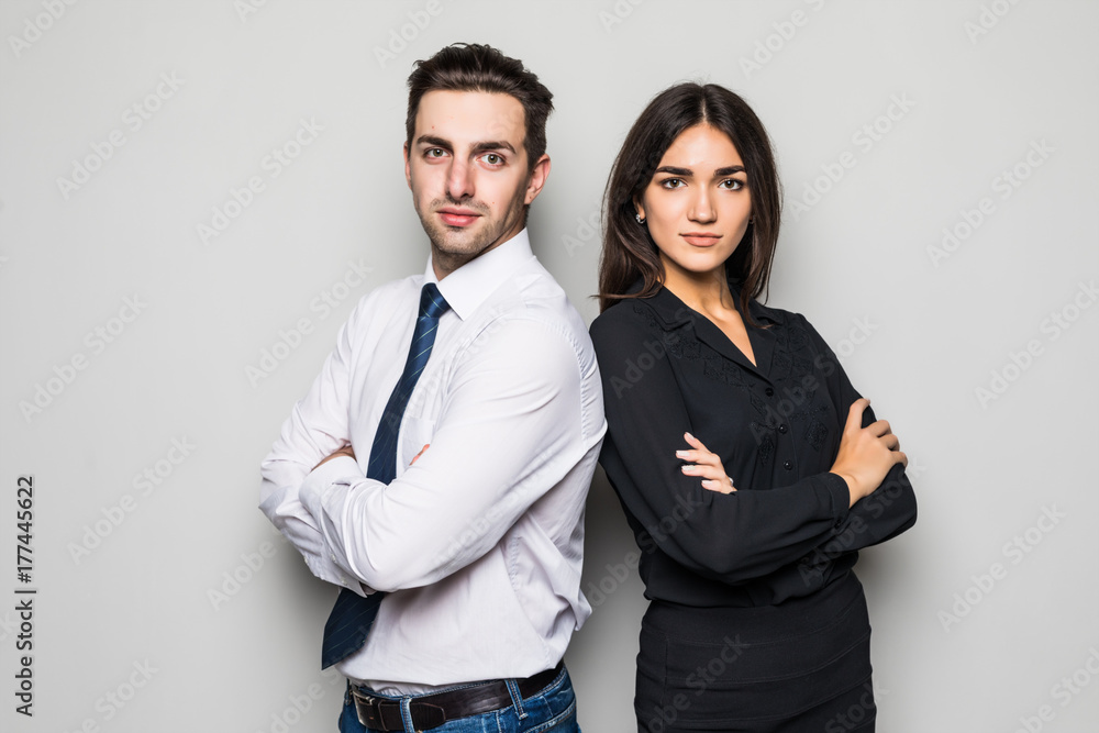 Man and woman standing back to back on gray background Man and woman standing back to back on gray background
