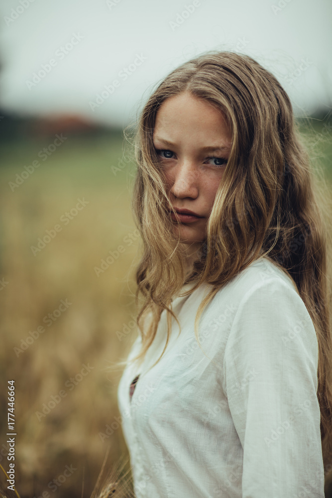 Portrait of a young girl in a field Portrait of a young girl in a field