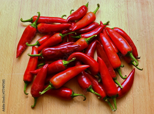 harvest autumn bunch from fresh cayenne red hot chili peppers on wooden table