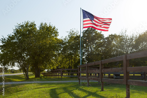 American flag in the yard of a house on sunset.