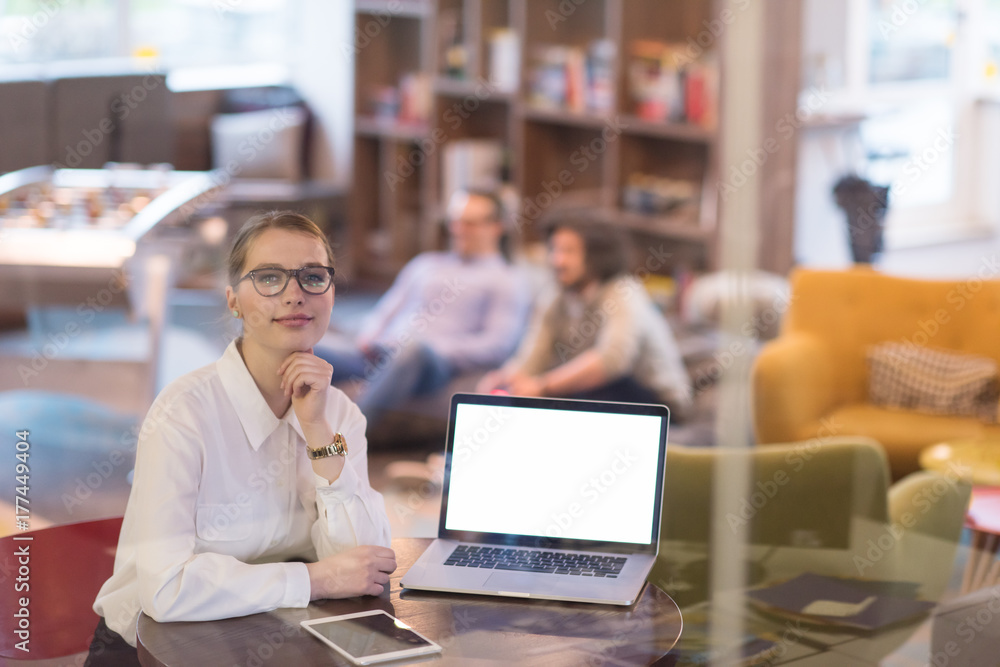 businesswoman using a laptop in startup office businesswoman using a laptop in startup office