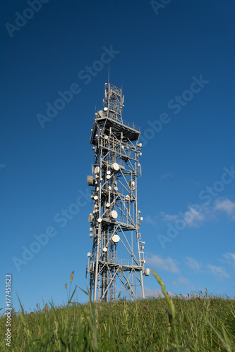 Telecommunications Tower against blue sky on top of Butser hillside outside of Petersfield and Clanfield, (Portsmouth, UK). photo