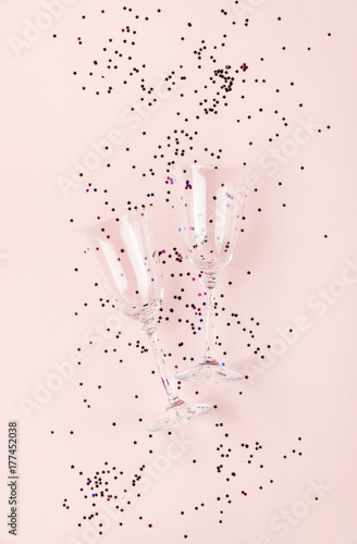 two champagne glasses isolated on an empty pink festive background