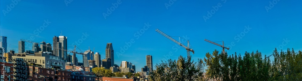Panoramic view of Montreal downtown with cranes