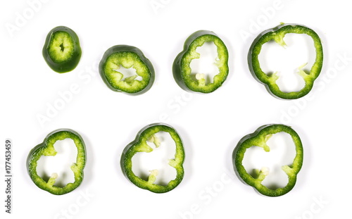 Green pepper slices isolated on white background, top view