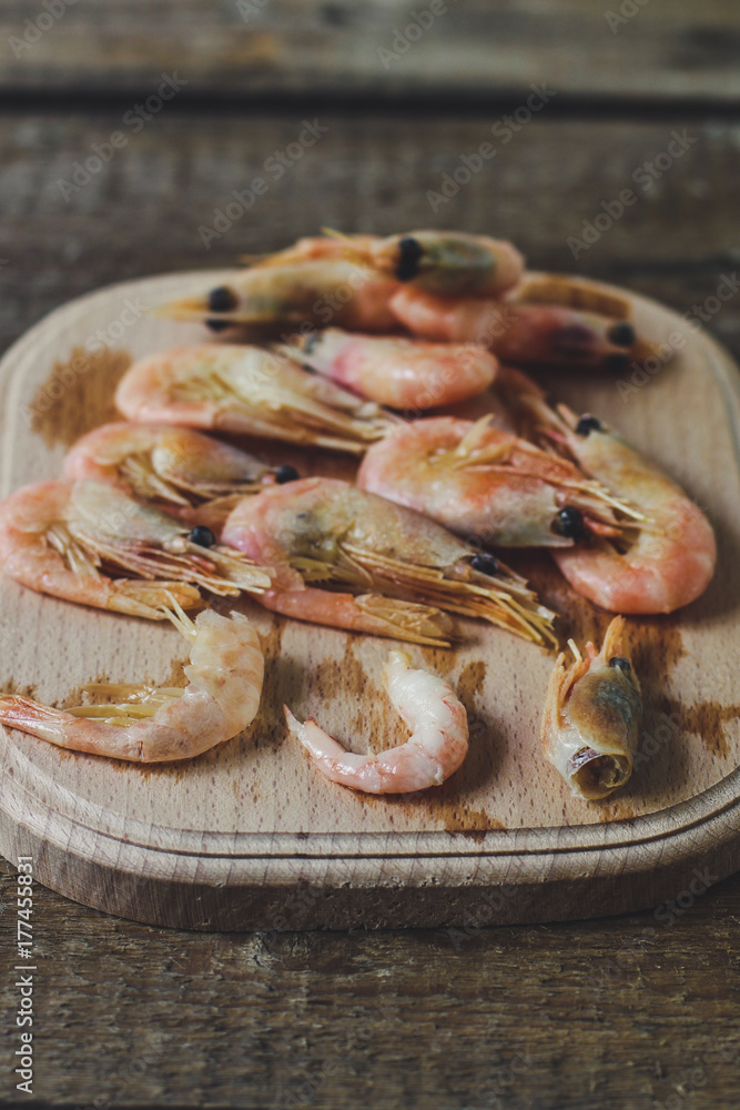 shrimp - a handful of seafood on a wooden background shrimp - a handful of seafood on a wooden background
