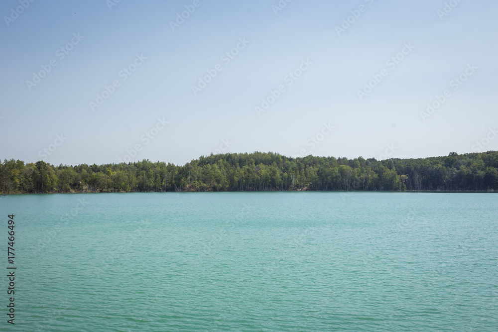Lake in a forest with clear turquoise water against a background of blue sky,beautifull lake,Beautiful turquoise lake,Vinnitsa lake Lake in a forest with clear turquoise water against a background of blue sky,beautifull lake,Beautiful turquoise lake,Vinnitsa lake