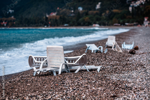 broken deckchairs on the beach © Nikita Shevchenko