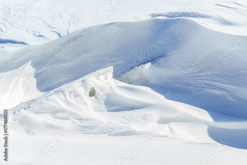 Ice lumps and big snowdrifts on a sunny winter day