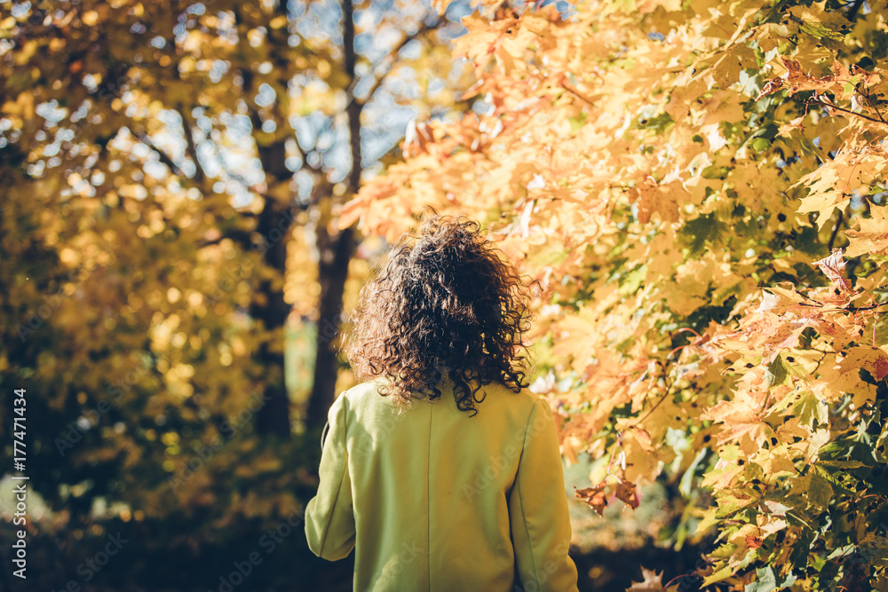 a lady watching a yellow leaf in autumn a lady watching a yellow leaf in autumn