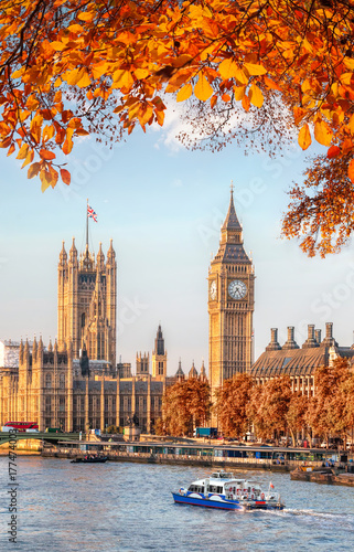 Big Ben with autumn leaves in London, England, UK