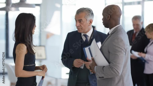 Wallpaper Mural  Business people at a conference meeting with other delegates in background Torontodigital.ca