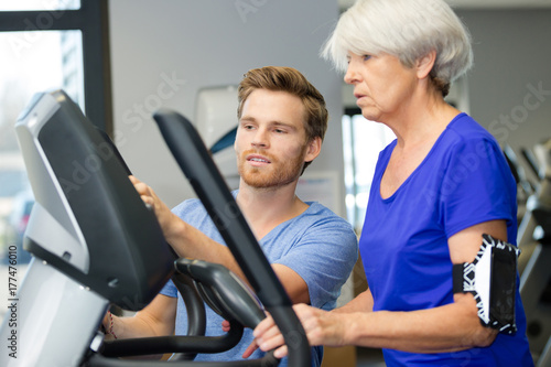 smiling woman training on machines in gym