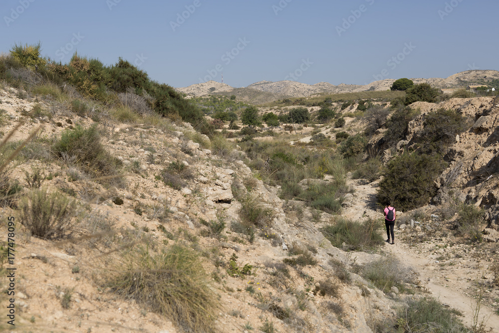 Woman walking in the mountains of Elche