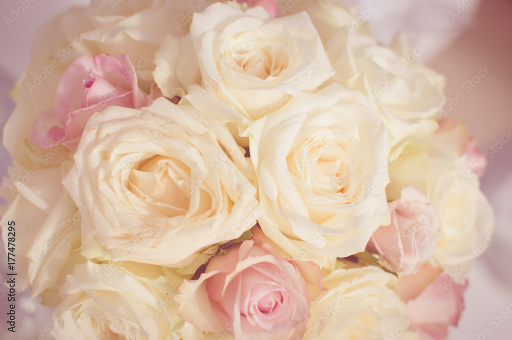 Close up on wedding flowers, bridal bouquet. Decoration made of roses over light celebration background Close up on wedding flowers, bridal bouquet. Decoration made of roses over light celebration background
